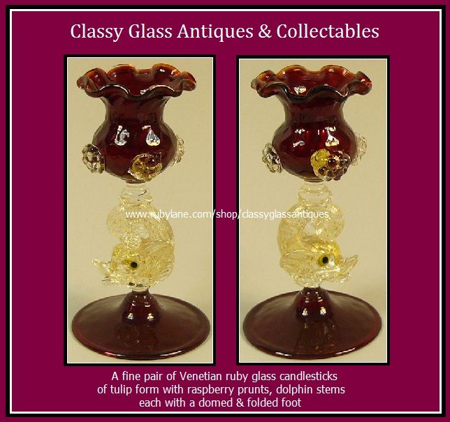 A Fine Pair of Venetian Murano Ruby Glass Dolphin Stem Candlestick Holders by Salviati A Fine Pair of Venetian Murano Ruby Glass Dolphin Stem Candlestick Holders by Salviati