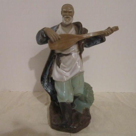 Chinese Mud man Playing an Instrument Chinese Mud man Playing an Instrument