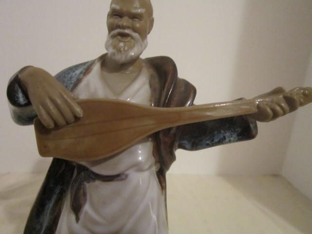 Chinese Mud man Playing an Instrument Chinese Mud man Playing an Instrument