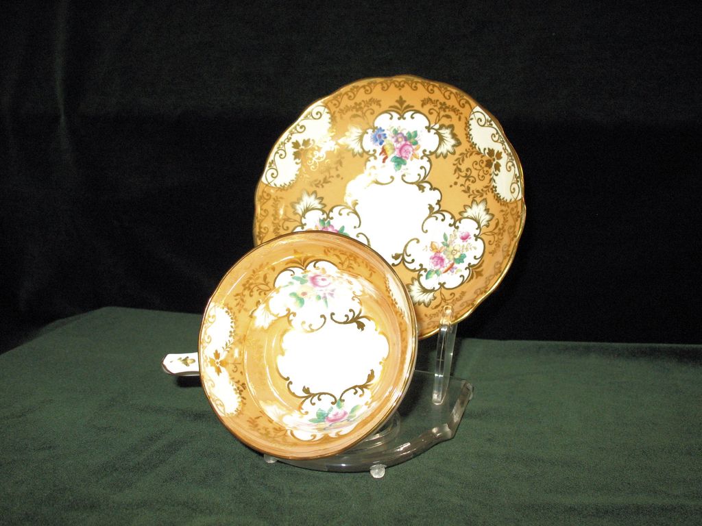 Hammersley Bone China Cup and Saucer in Apricot with Gold trim and medallions filled with floral décor Hammersley Bone China Cup and Saucer in Apricot with Gold trim and medallions filled with floral décor