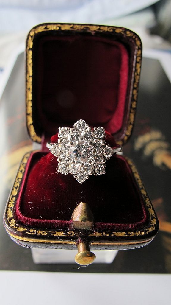 A diamond ring designed as a cluster, set in a 14 k white gold mount A diamond ring designed as a cluster, set in a 14 k white gold mount