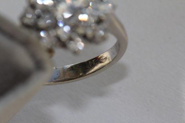 A diamond ring designed as a cluster, set in a 14 k white gold mount A diamond ring designed as a cluster, set in a 14 k white gold mount