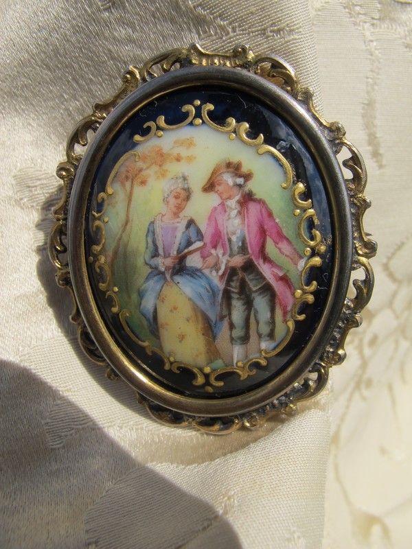 Antique Enamel brooch depicting a courting couple, set in gilded silver mounting Antique Enamel brooch depicting a courting couple, set in gilded silver mounting