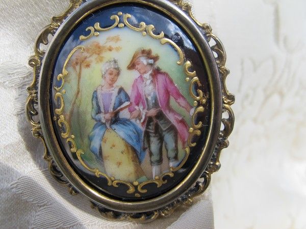 Antique Enamel brooch depicting a courting couple, set in gilded silver mounting Antique Enamel brooch depicting a courting couple, set in gilded silver mounting
