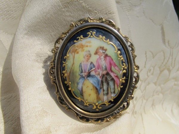 Antique Enamel brooch depicting a courting couple, set in gilded silver mounting Antique Enamel brooch depicting a courting couple, set in gilded silver mounting