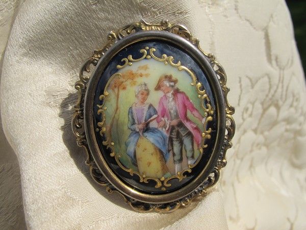 Antique Enamel brooch depicting a courting couple, set in gilded silver mounting Antique Enamel brooch depicting a courting couple, set in gilded silver mounting