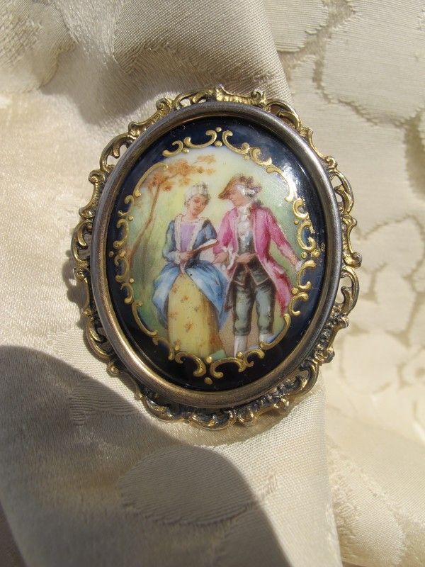 Antique Enamel brooch depicting a courting couple, set in gilded silver mounting Antique Enamel brooch depicting a courting couple, set in gilded silver mounting