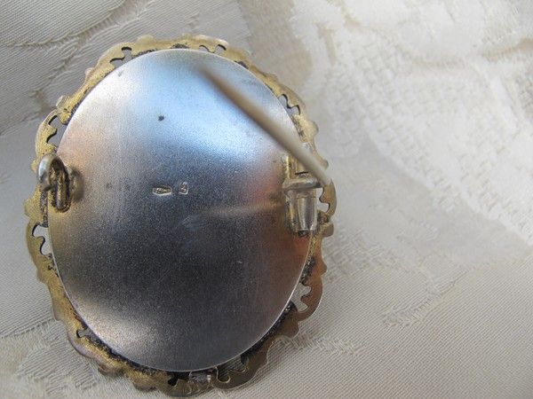 Antique Enamel brooch depicting a courting couple, set in gilded silver mounting Antique Enamel brooch depicting a courting couple, set in gilded silver mounting