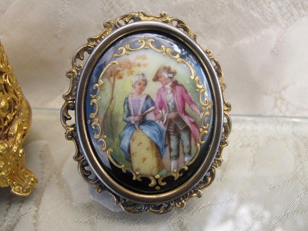 Antique Enamel brooch depicting a courting couple, set in gilded silver mounting Antique Enamel brooch depicting a courting couple, set in gilded silver mounting