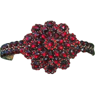 Antique Bohemian Garnet bangle in the shape of a flower head, dated at about 1900 Antique Bohemian Garnet bangle in the shape of a flower head, dated at about 1900