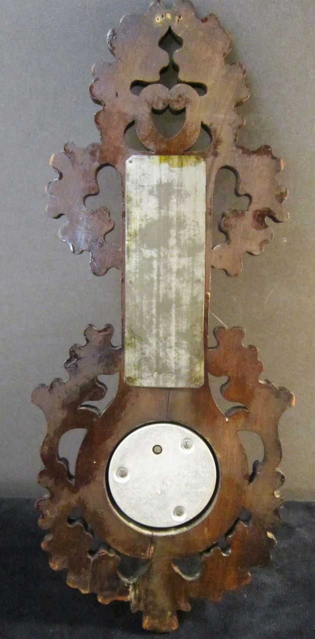 A Vintage Black Forest Carved Walnut Barometer and Thermometer A Vintage Black Forest Carved Walnut Barometer and Thermometer