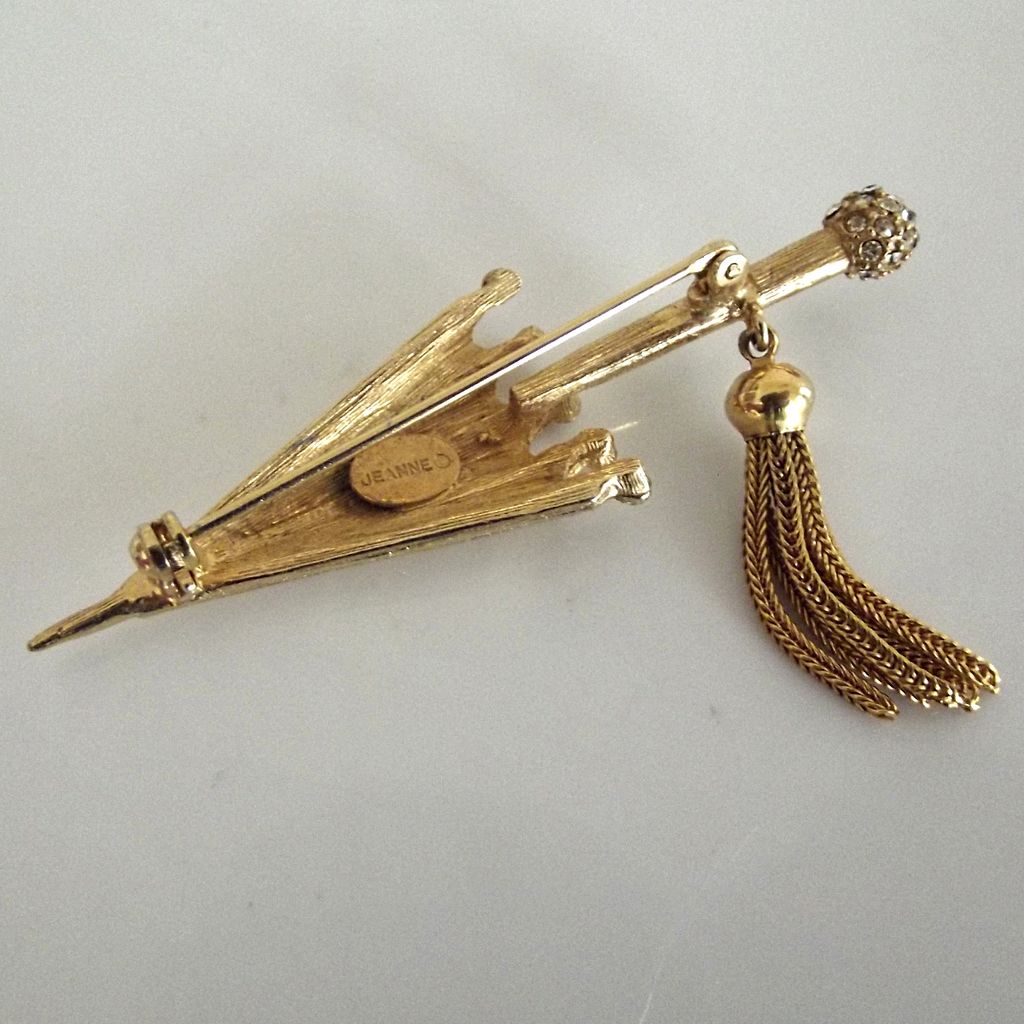Jeanne Gold Tone Umbrella Pin with Tassel and Rhinestones Jeanne Gold Tone Umbrella Pin with Tassel and Rhinestones