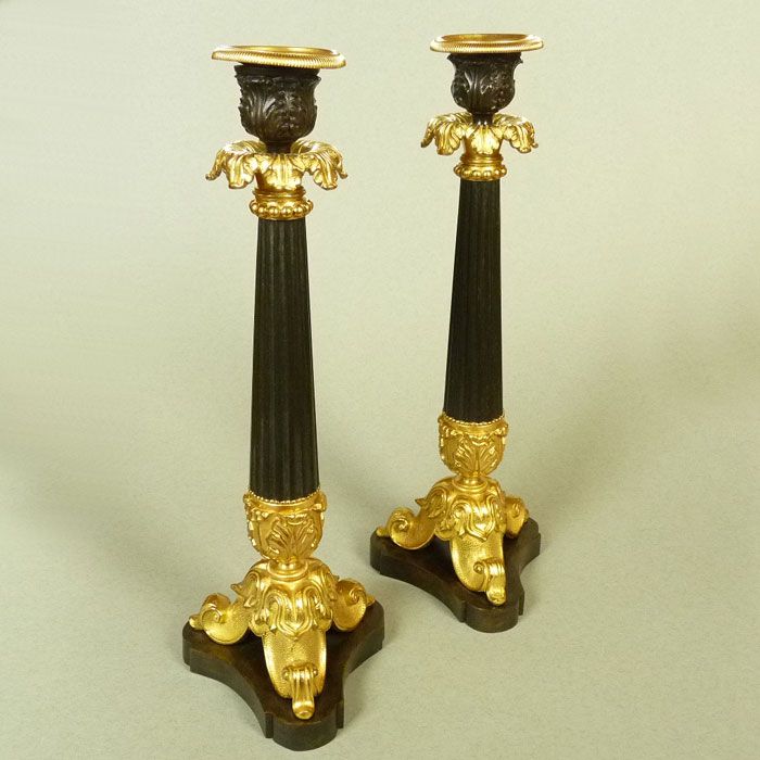A Pair of Classical French Bronze and Gilt Bronze Candlesticks A Pair of Classical French Bronze and Gilt Bronze Candlesticks