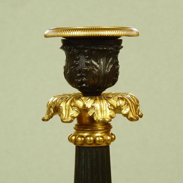 A Pair of Classical French Bronze and Gilt Bronze Candlesticks A Pair of Classical French Bronze and Gilt Bronze Candlesticks