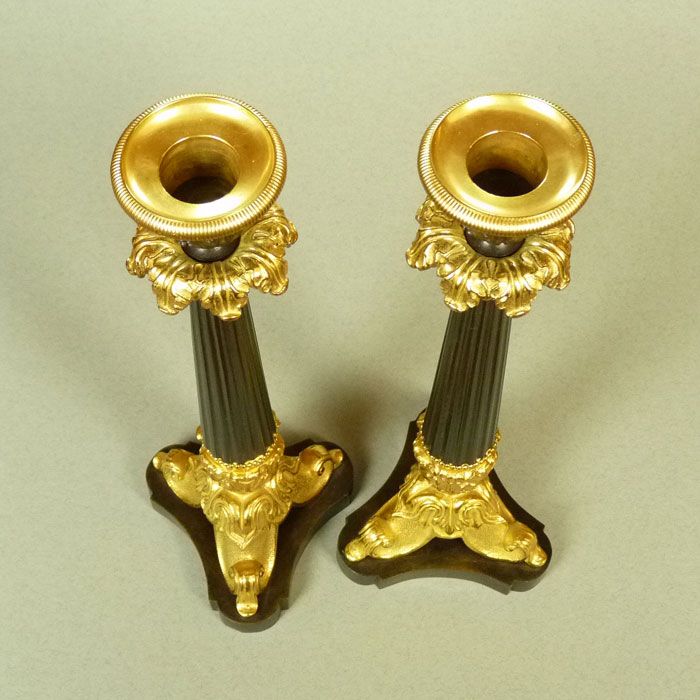 A Pair of Classical French Bronze and Gilt Bronze Candlesticks A Pair of Classical French Bronze and Gilt Bronze Candlesticks