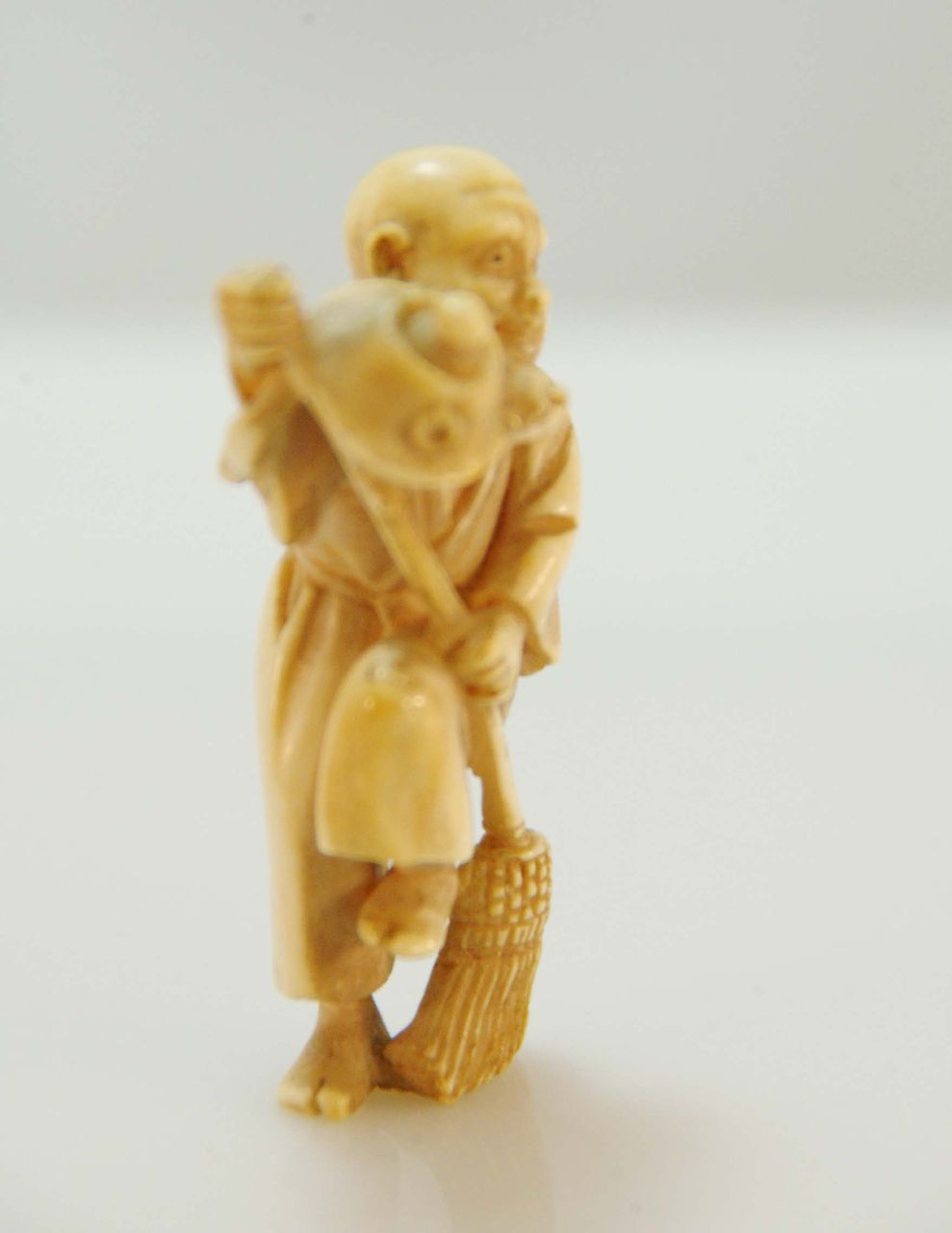 Carved Ivory Netsuke of Man with Broom and Teapot with Mouse c. 19th C. Carved Ivory Netsuke of Man with Broom and Teapot with Mouse c. 19th C.