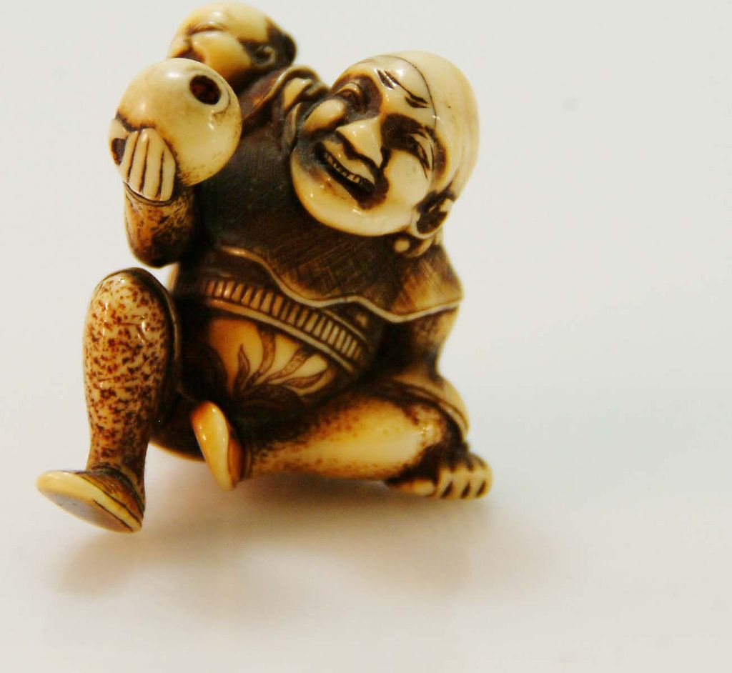 Hand Carved Ivory Netsuke of Man with Child on Back c. 19th C. Hand Carved Ivory Netsuke of Man with Child on Back c. 19th C.