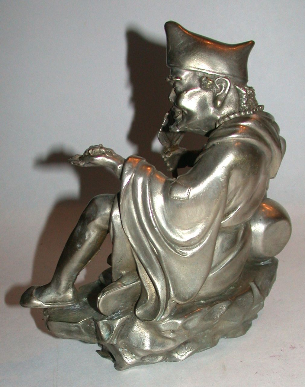 Antique Chinese Silvered Bronze Of Immortal, Seated And Holding A Fan and An Insect (Cicada) Antique Chinese Silvered Bronze Of Immortal, Seated And Holding A Fan and An Insect (Cicada)