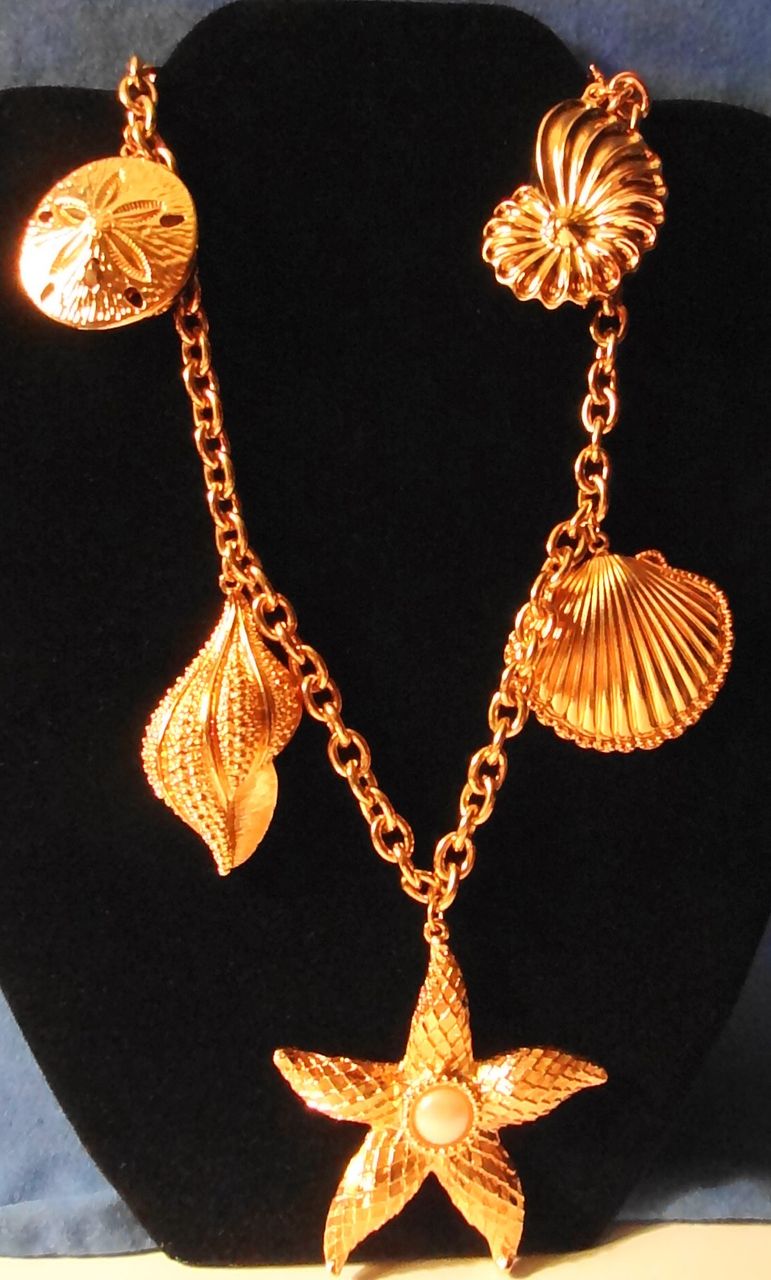Kenneth Jay Lane's Avon 1992 "Royal Sea Collection" ~ Gold-tone Sea Shell Motif necklace & clip earrings. Kenneth Jay Lane's Avon 1992 "Royal Sea Collection" ~ Gold-tone Sea Shell Motif necklace & clip earrings.