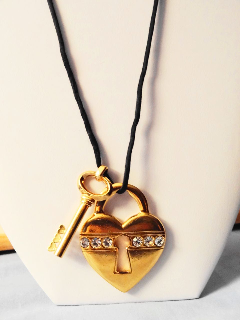 Avon's 1993 "Unlock My Heart Necklace" ~ gold-tone heart and key on black cord Avon's 1993 "Unlock My Heart Necklace" ~ gold-tone heart and key on black cord