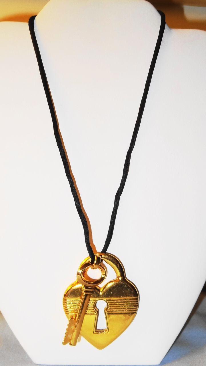 Avon's 1993 "Unlock My Heart Necklace" ~ gold-tone heart and key on black cord Avon's 1993 "Unlock My Heart Necklace" ~ gold-tone heart and key on black cord