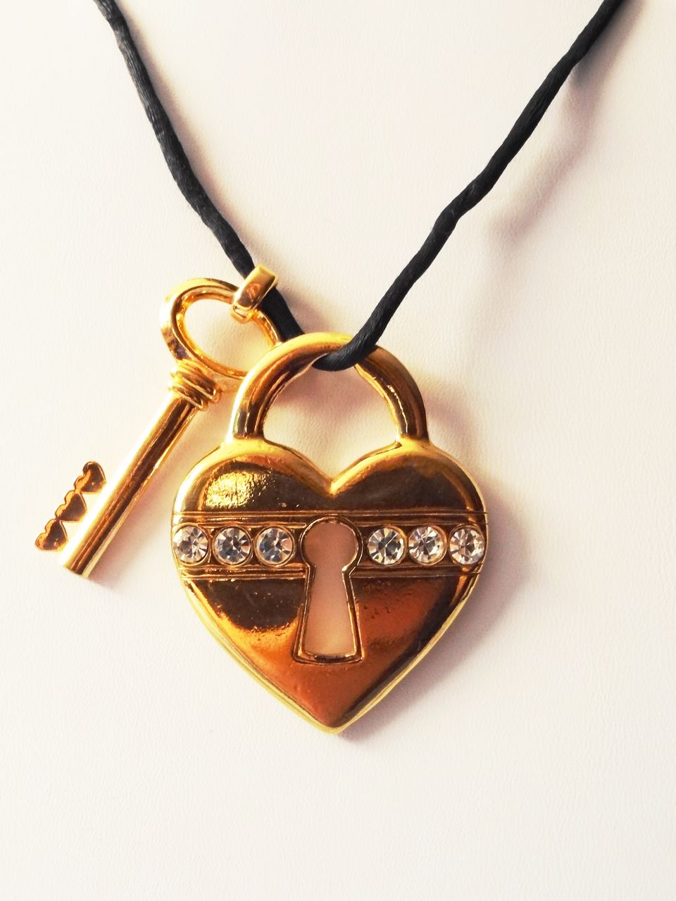 Avon's 1993 "Unlock My Heart Necklace" ~ gold-tone heart and key on black cord Avon's 1993 "Unlock My Heart Necklace" ~ gold-tone heart and key on black cord