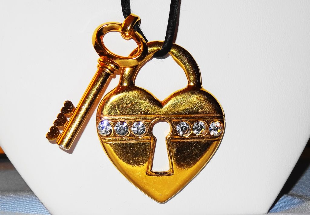 Avon's 1993 "Unlock My Heart Necklace" ~ gold-tone heart and key on black cord Avon's 1993 "Unlock My Heart Necklace" ~ gold-tone heart and key on black cord