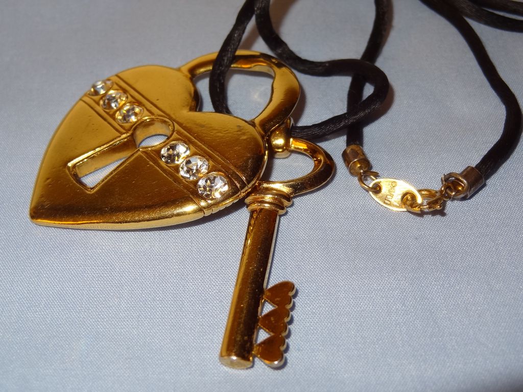 Avon's 1993 "Unlock My Heart Necklace" ~ gold-tone heart and key on black cord Avon's 1993 "Unlock My Heart Necklace" ~ gold-tone heart and key on black cord