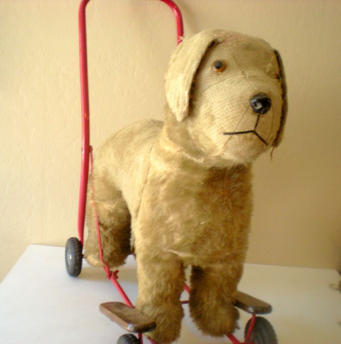 toy dog on wheels with lead