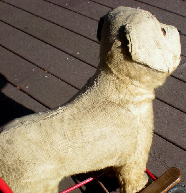toy dog on wheels with lead