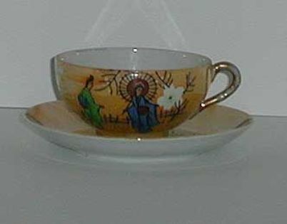 Painted Porcelain lustre geisha cup and saucer Painted Porcelain lustre geisha cup and saucer