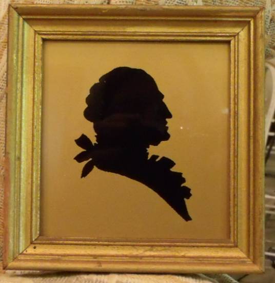 Silhouette of Martha and George Washington Under Glass on Gold Background Silhouette of Martha and George Washington Under Glass on Gold Background