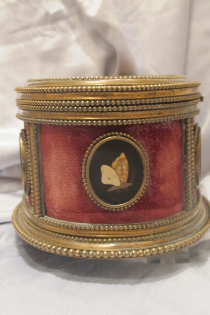 A Florentine gilt brass and Pietra Dura mounted oval casket, 19th century A Florentine gilt brass and Pietra Dura mounted oval casket, 19th century