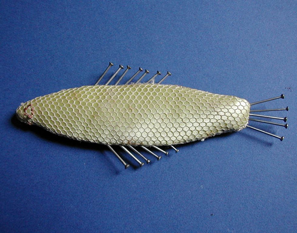 An early 19th century hand made pin cushion in the form of a fish. An early 19th century hand made pin cushion in the form of a fish.