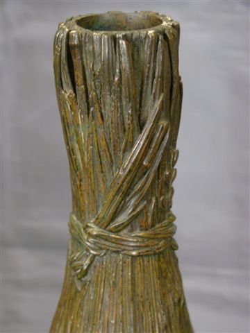 Antique bronze detailed vase with flowers and reeds Antique bronze detailed vase with flowers and reeds