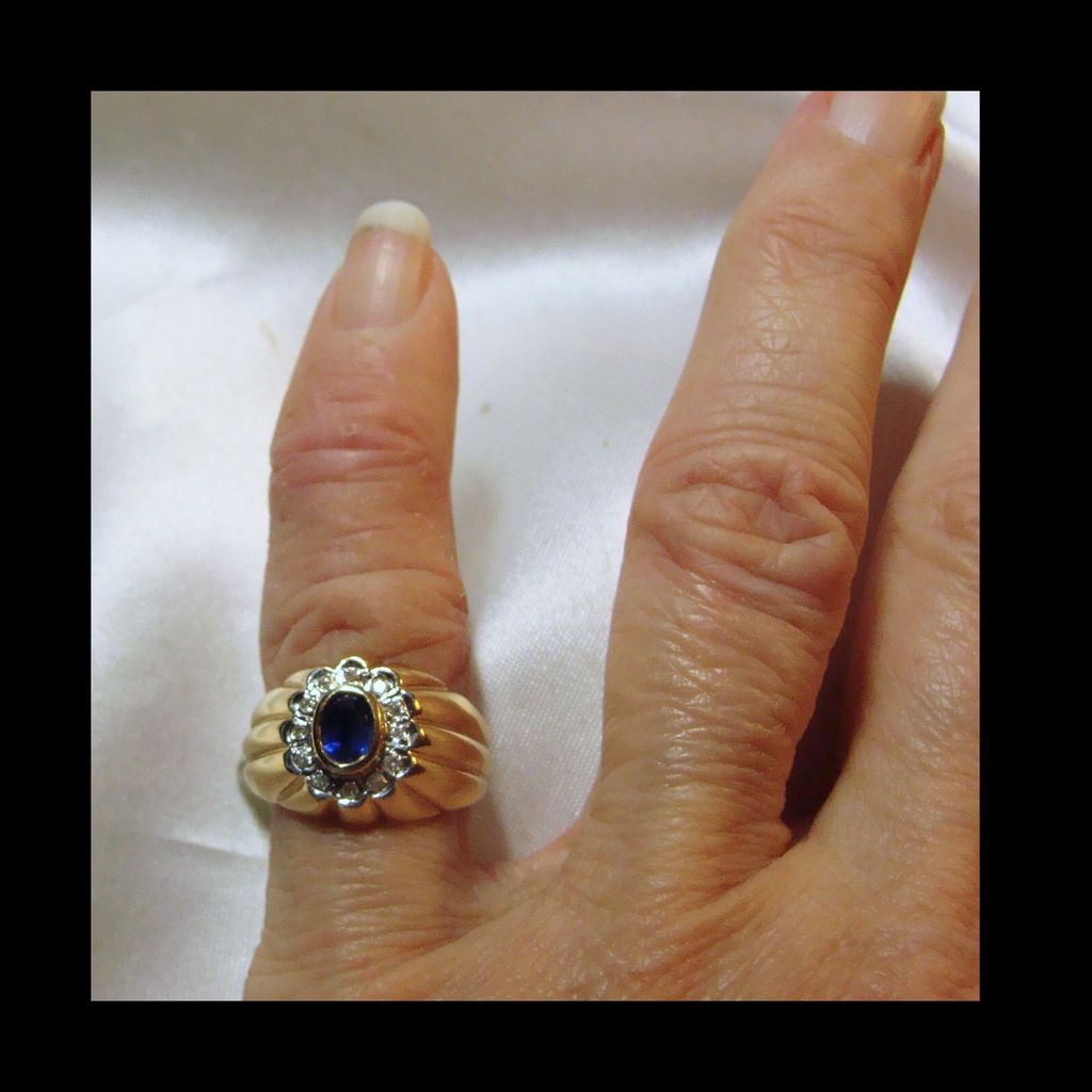 Sapphire Surrounded by Diamonds in a 14k Yellow Gold Ring Sapphire Surrounded by Diamonds in a 14k Yellow Gold Ring