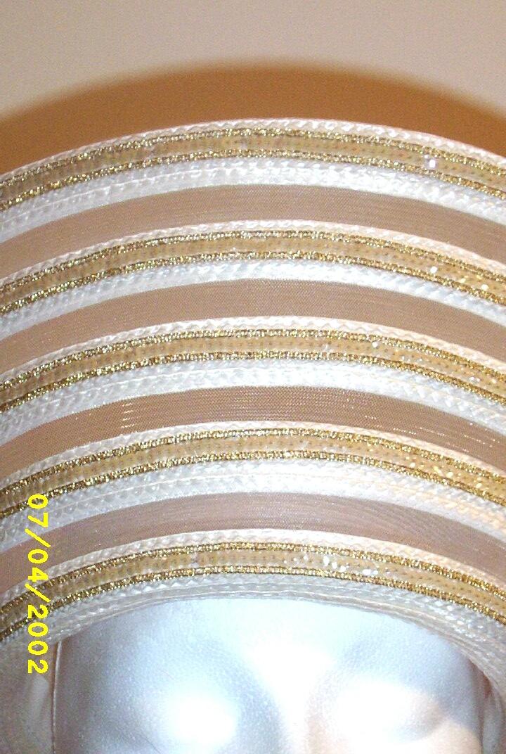 White Synthetic Straw Long Up-Turned Brim Hat With Alternating Rows Of Straw. Sheer Horse Hair, And Gold Sequin Trim White Synthetic Straw Long Up-Turned Brim Hat With Alternating Rows Of Straw. Sheer Horse Hair, And Gold Sequin Trim