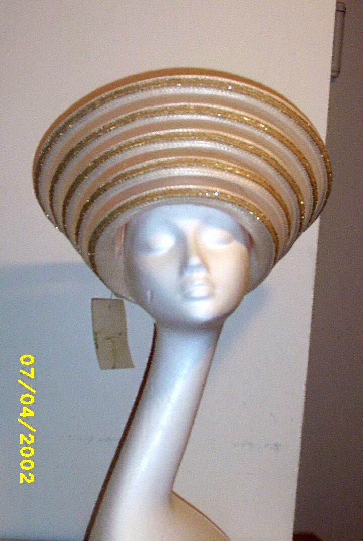 White Synthetic Straw Long Up-Turned Brim Hat With Alternating Rows Of Straw. Sheer Horse Hair, And Gold Sequin Trim White Synthetic Straw Long Up-Turned Brim Hat With Alternating Rows Of Straw. Sheer Horse Hair, And Gold Sequin Trim