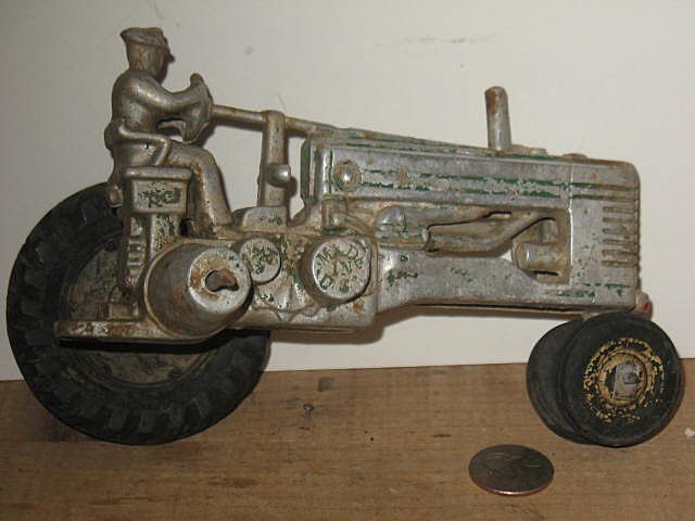 1940's Cast Aluminum John Deere Tractor with a Rider 1940's Cast Aluminum John Deere Tractor with a Rider