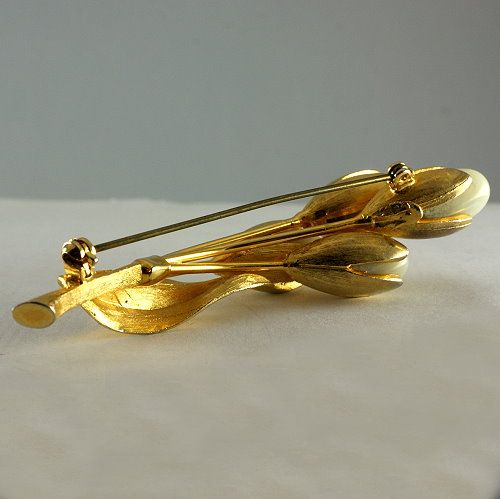 Long floral brooch with unusual opaque stone buds gold tone really nice Long floral brooch with unusual opaque stone buds gold tone really nice