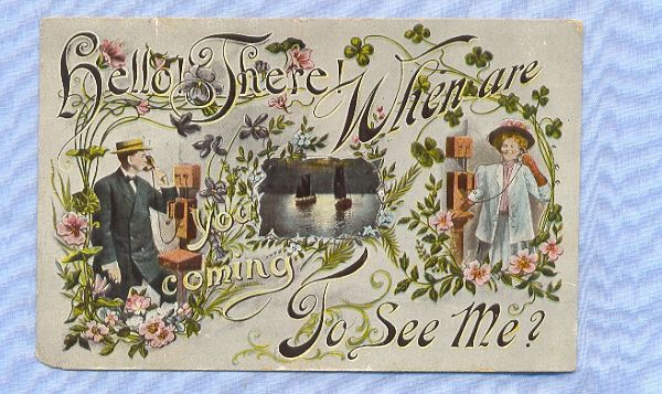 Postcard with Couple Talking on Vintage Wall Telephones, Circa 1910 Postcard with Couple Talking on Vintage Wall Telephones, Circa 1910