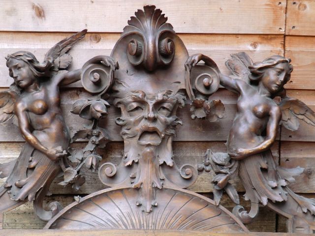 Ornately carved Armorial Overdoor with Grotesque flanked by Winged Angels Ornately carved Armorial Overdoor with Grotesque flanked by Winged Angels