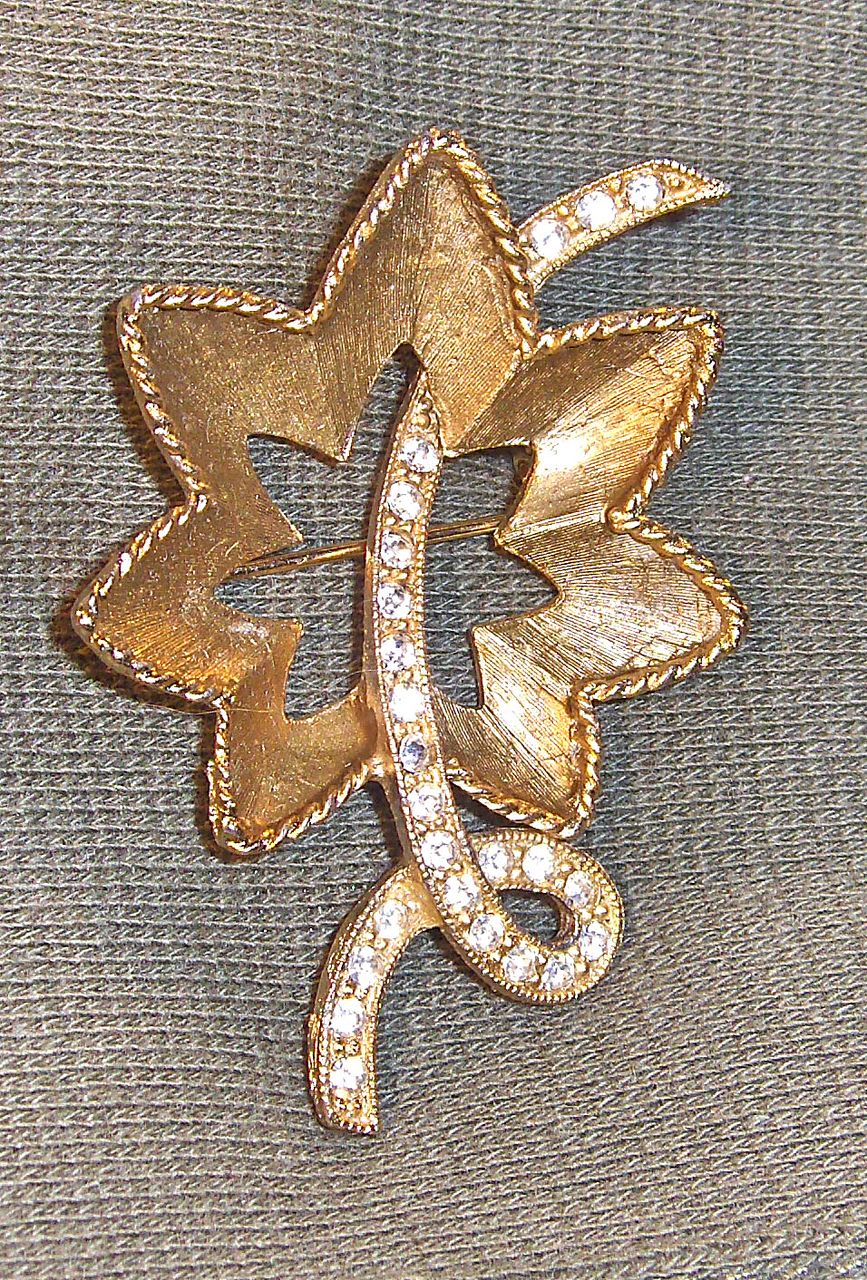 Lovely Flower Pin with Clear Rhinestones on Gold Tone Background Lovely Flower Pin with Clear Rhinestones on Gold Tone Background