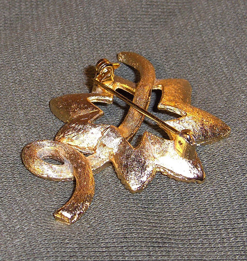 Lovely Flower Pin with Clear Rhinestones on Gold Tone Background Lovely Flower Pin with Clear Rhinestones on Gold Tone Background