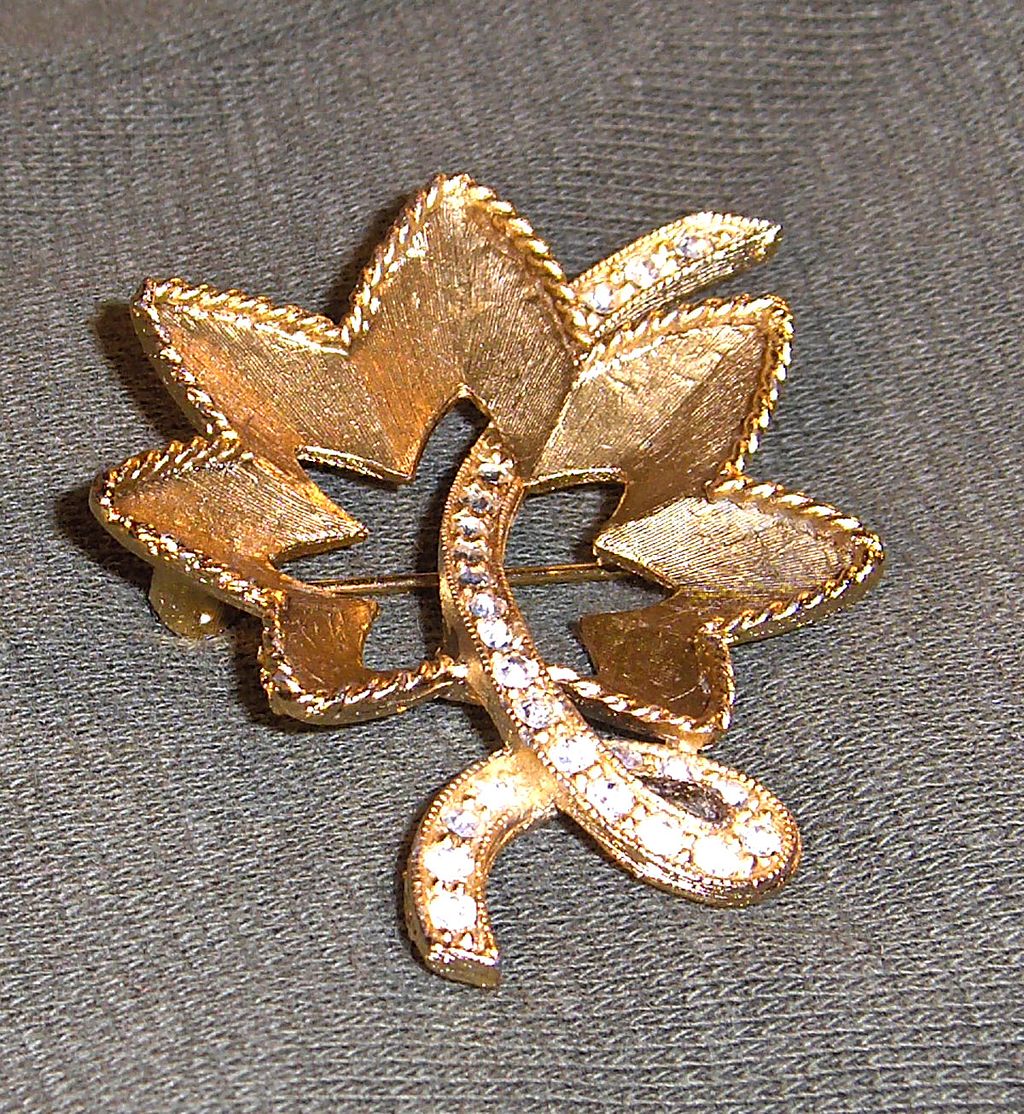 Lovely Flower Pin with Clear Rhinestones on Gold Tone Background Lovely Flower Pin with Clear Rhinestones on Gold Tone Background