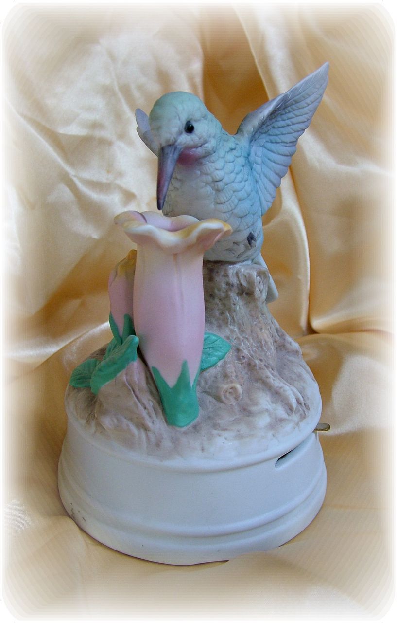 Music box figure hummingbird on trumpet flower pastel colors Music box figure hummingbird on trumpet flower pastel colors