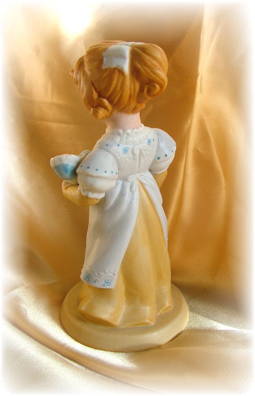 Vintage old fashioned little girl with doll figurine Vintage old fashioned little girl with doll figurine