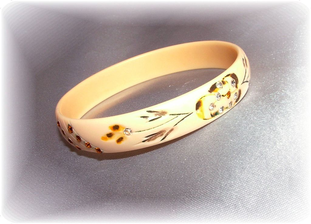 Vintage celluloid bangle bracelet with carving, hand painting and clear and amber rhinestones Vintage celluloid bangle bracelet with carving, hand painting and clear and amber rhinestones