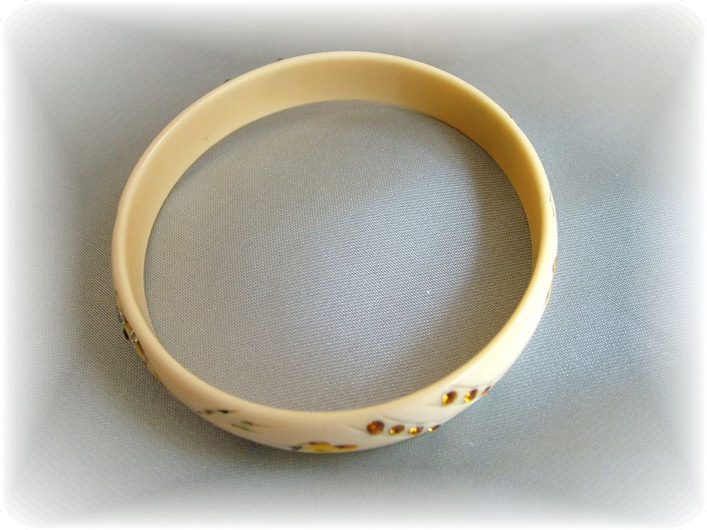 Vintage celluloid bangle bracelet with carving, hand painting and clear and amber rhinestones Vintage celluloid bangle bracelet with carving, hand painting and clear and amber rhinestones