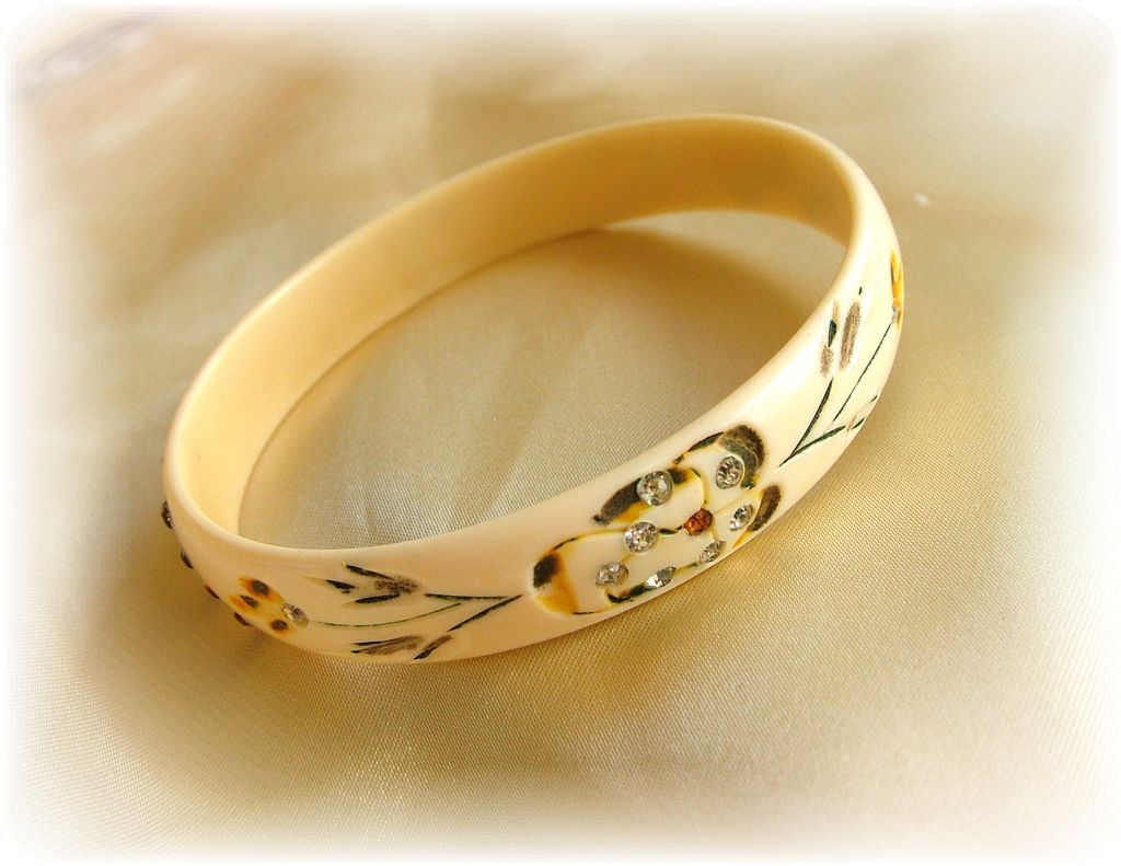 Vintage celluloid bangle bracelet with carving, hand painting and clear and amber rhinestones Vintage celluloid bangle bracelet with carving, hand painting and clear and amber rhinestones